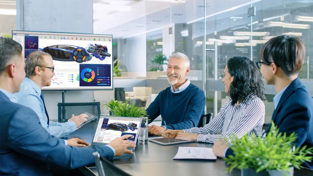 5 people in meeting room with 4K display on wall